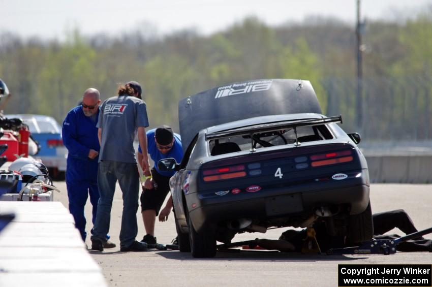 Generations Nissan 300ZX in the pits early on.