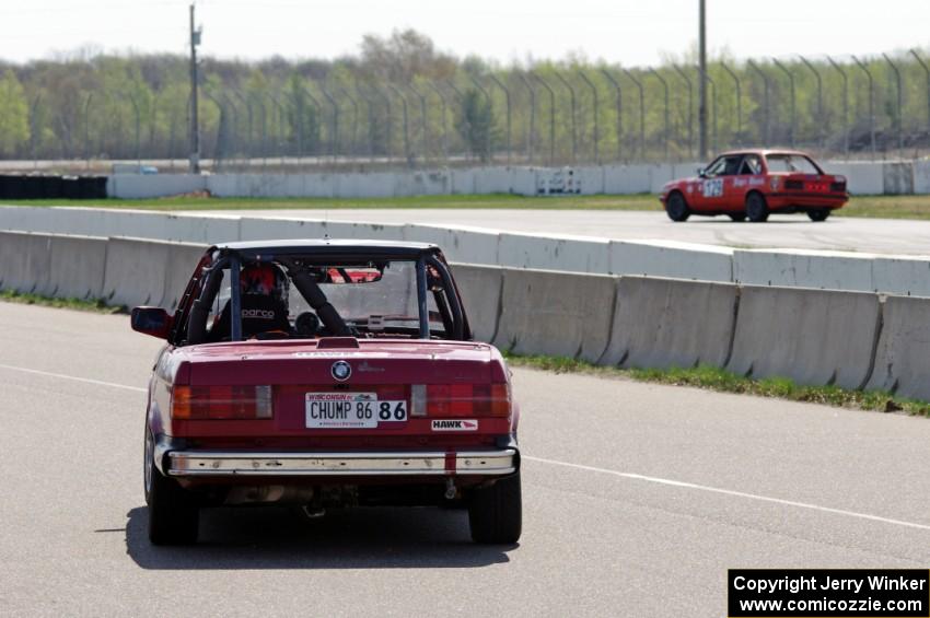 Missing Link Motorsports BMW 325i leaves the pits after a driver's change.