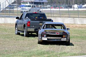 Errora Olds Aurora is towed back to the pits after losing all coolant.