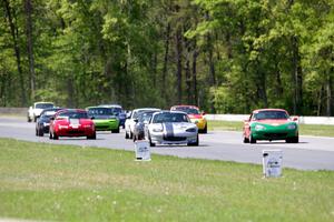 The field of Spec Miatas all bunched together into turn 4 on the first lap.