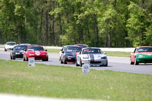 The field of Spec Miatas all bunched together into turn 4 on the first lap.
