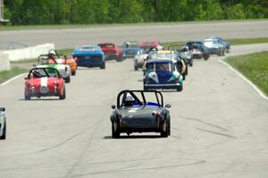 Phil Schaefer's Austin-Healey Sprite brings up the rear of the vintage field as the cars take the green flag at turn 1.