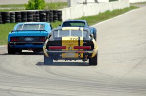 Shannon Ivey's Ford Mustang Shelby GT350 chases Darwin Bosell's Chevy Corvette and Brian Kennedy's Ford Mustang