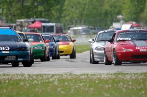 The field of Spec Miatas comes into turn 12 on the pace lap
