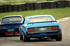 Brian Kennedy's Ford Mustang chases Darwin Bosell's Chevy Corvette