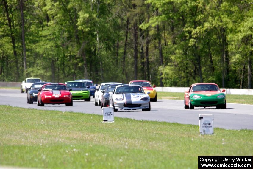 The field of Spec Miatas all bunched together into turn 4 on the first lap.