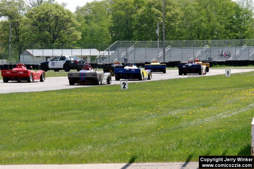 The Spec Racer Ford field comes through turn 12 on the pace lap.