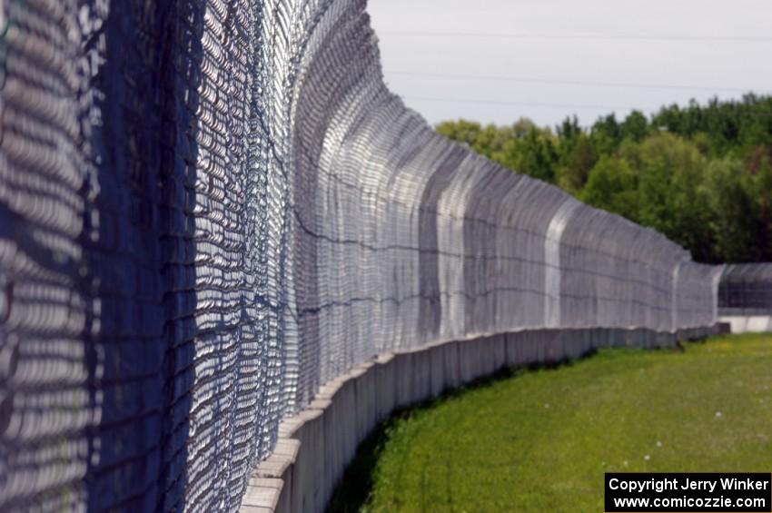 The fenceline between turns six and five.