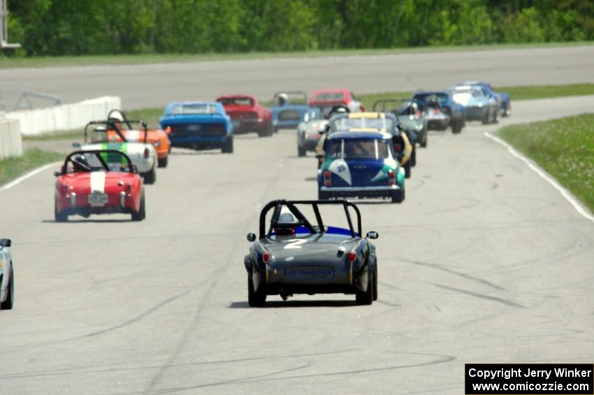 Phil Schaefer's Austin-Healey Sprite brings up the rear of the vintage field as the cars take the green flag at turn 1.