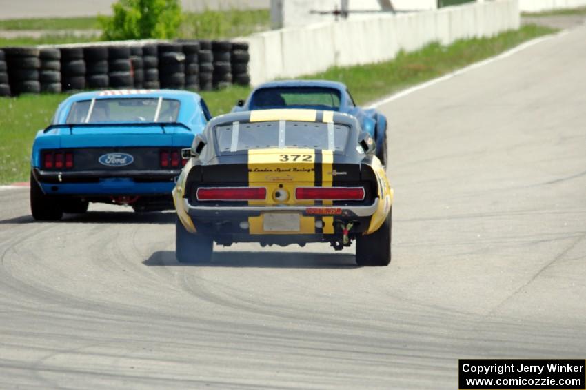 Shannon Ivey's Ford Mustang Shelby GT350 chases Darwin Bosell's Chevy Corvette and Brian Kennedy's Ford Mustang