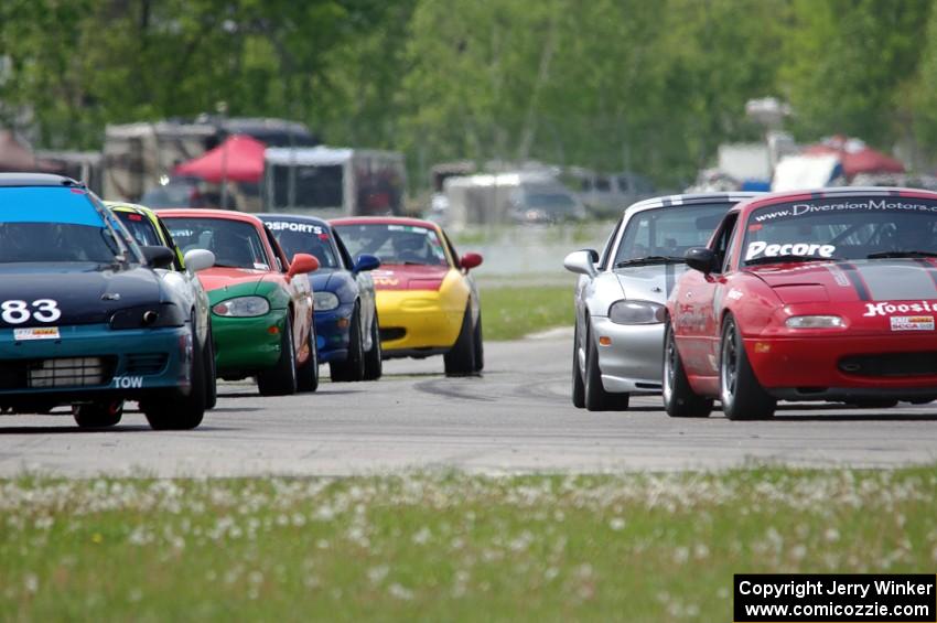 The field of Spec Miatas comes into turn 12 on the pace lap