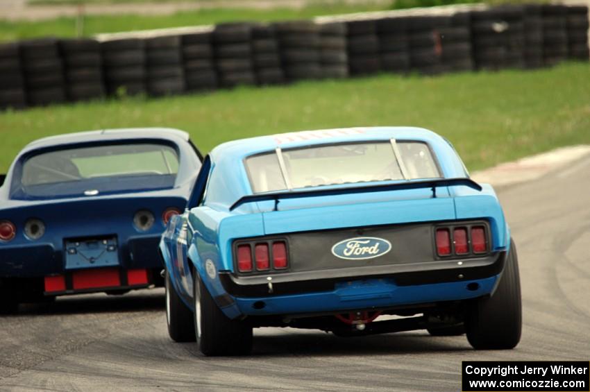 Brian Kennedy's Ford Mustang chases Darwin Bosell's Chevy Corvette