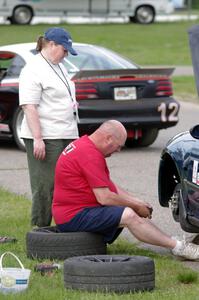 Mark Utecht works on his ITJ Honda Civic as his wife Mary watches.