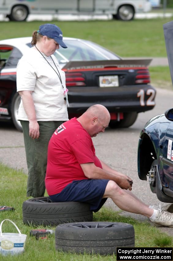 Mark Utecht works on his ITJ Honda Civic as his wife Mary watches.