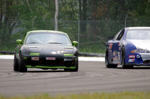 Aaron Jongbloedt's PTE Mazda Miata passes John Vining's SU Chevy Monte Carlo