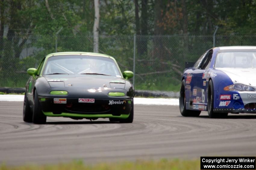 Aaron Jongbloedt's PTE Mazda Miata passes John Vining's SU Chevy Monte Carlo