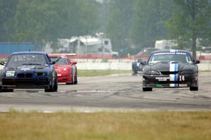 Jeff Demetri's American Iron Ford Mustang passes Terry Orr's GTS4 BMW M3 and John Boos' SU Chevy Corvette