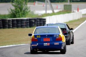 Andy Orr's GTS2 BMW 325i chases Jeff Demetri's American Iron Ford Mustang
