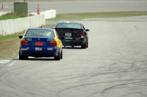 Andy Orr's GTS2 BMW 325i chases Jeff Demetri's American Iron Ford Mustang