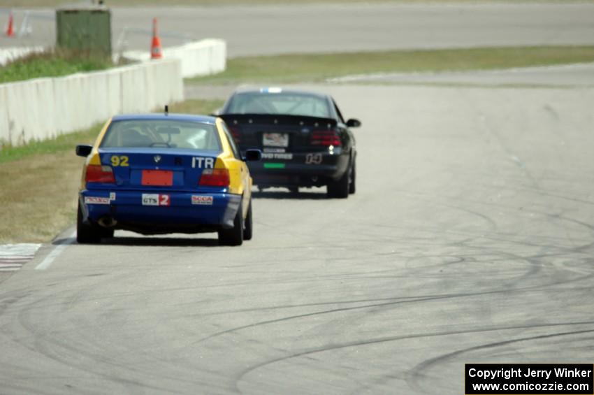 Andy Orr's GTS2 BMW 325i chases Jeff Demetri's American Iron Ford Mustang