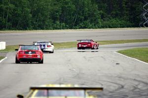Amy Ruman's Chevy Corvette and Cliff Ebben's Ford Mustang chased by Tim Rubright's Ford Mustang