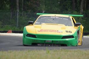 John Baucom's Ford Mustang limps around the track with another flat tire.