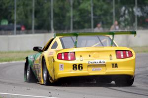John Baucom's Ford Mustang limps around the track with another flat tire.