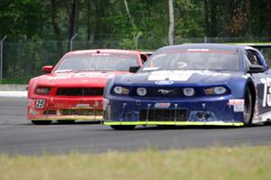 Ron Keith's Ford Mustang about to pass Kevin Poitras' Ford Mustang at the carousel