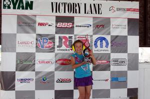 A young fan poses with one of the Trans-Am trophies.