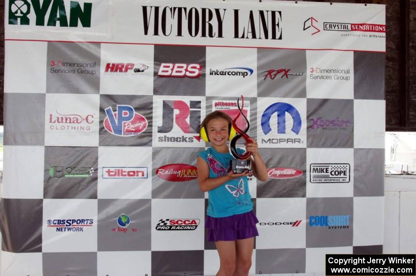 A young fan poses with one of the Trans-Am trophies.