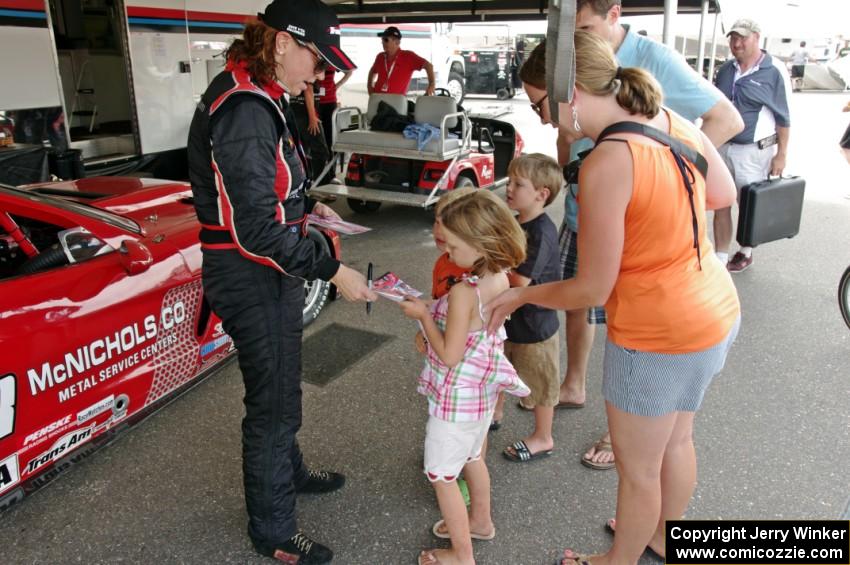 Amy Ruman signs autographs for young fans.