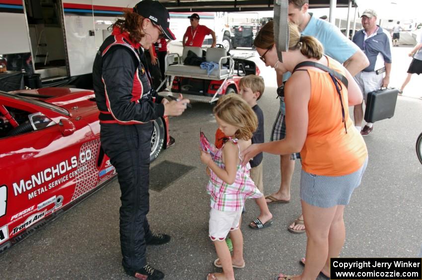 Amy Ruman signs autographs for young fans.