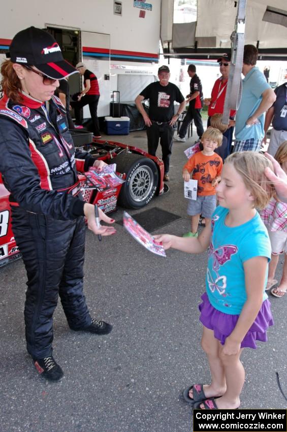 Amy Ruman signs an autograph for a young fan.