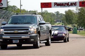 Purple-Headed Chumps Ford Mustang gets towed back to the pits.