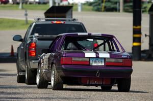 Purple-Headed Chumps Ford Mustang gets towed back to the pits.