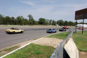 North Loop Motorsport BMW 325i and Rat Patrol Triumph TR-7 chase a pack through turn 10.