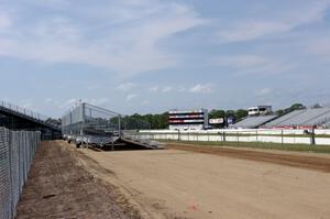 New small grandstands being installed near the end of the quarter mile after heavy winds destroyed the old ones.