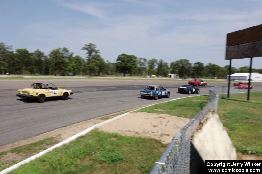 North Loop Motorsport BMW 325i and Rat Patrol Triumph TR-7 chase a pack through turn 10.