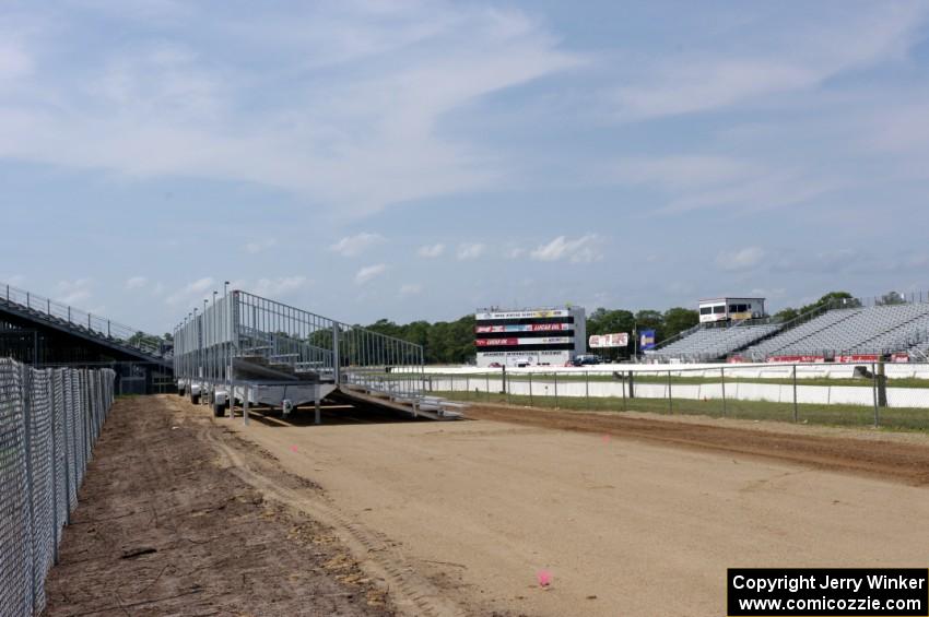 New small grandstands being installed near the end of the quarter mile after heavy winds destroyed the old ones.