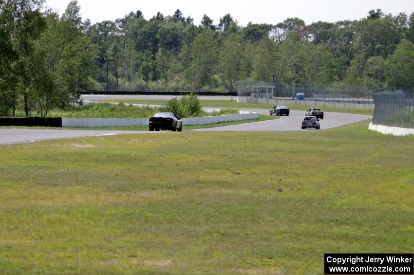 ProKart Racing Chevy Camaro chases three BMWs into turns 7 and 8.
