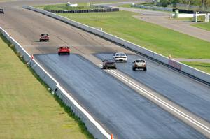 Five cars head down the front straight into turn 1.