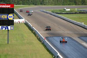 The Most Interesting Chumps In The World BMW 325i and Bromance Racing Ford Mustang chase a group of cars down the front straight