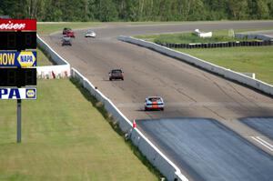 The Most Interesting Chumps In The World BMW 325i and Bromance Racing Ford Mustang chase a group of cars down the front straight