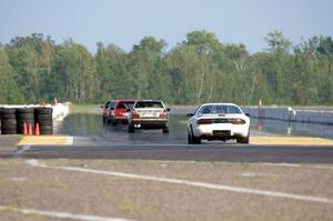 Five cars head out of turn 10 onto the front straight.