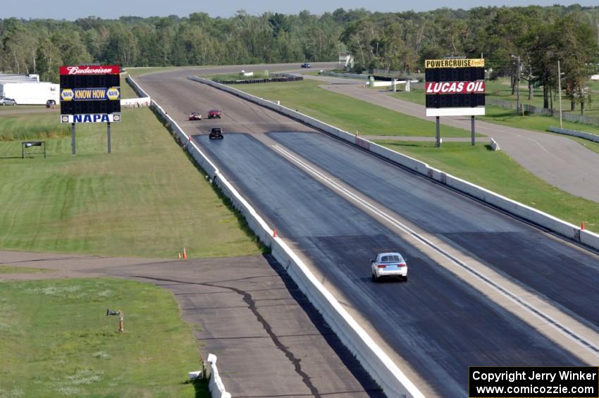 Fart-Hinder Racing SAAB 9-3 chases three other cars down the front straight.