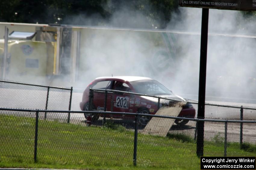 Three Sheets Racing Ford Focus ZX3 recovers after having a spin headed into turn 10.