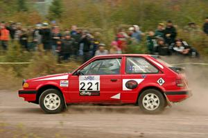 Jimmy Pelizzari / Sara Stevens Mazda 323GTX comes through the SS1 (Green Acres I) spectator area.