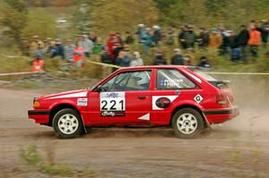 Jimmy Pelizzari / Sara Stevens Mazda 323GTX comes through the SS1 (Green Acres I) spectator area.