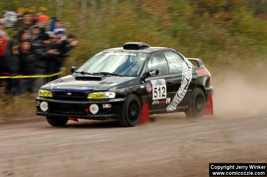 Corey Holmes / Dustin Masters Subaru Impreza comes through the SS1 (Green Acres I) spectator area.