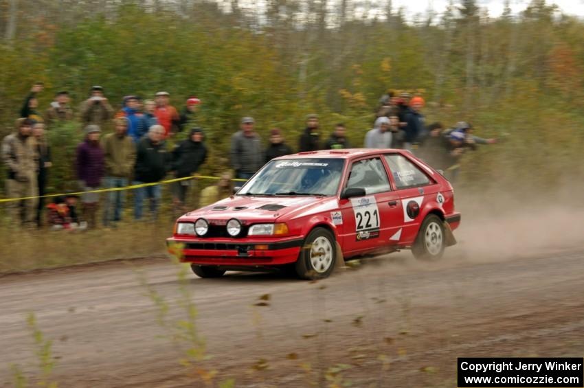Jimmy Pelizzari / Kate Stevens Mazda 323GTX comes through the SS1 (Green Acres I) spectator area.